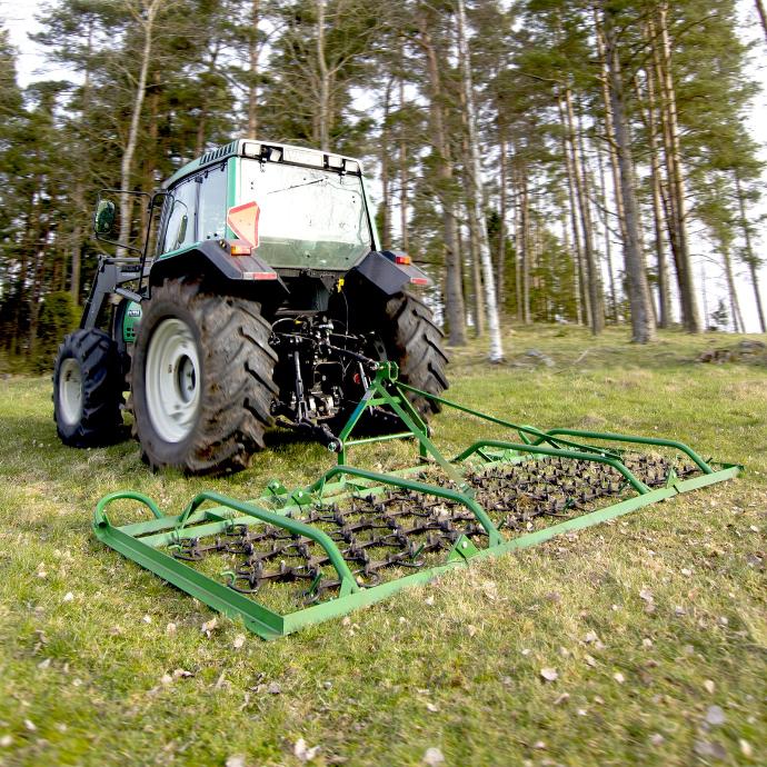 Chain Harrow harrowing a paddock with a tractor mounted chain harrow
