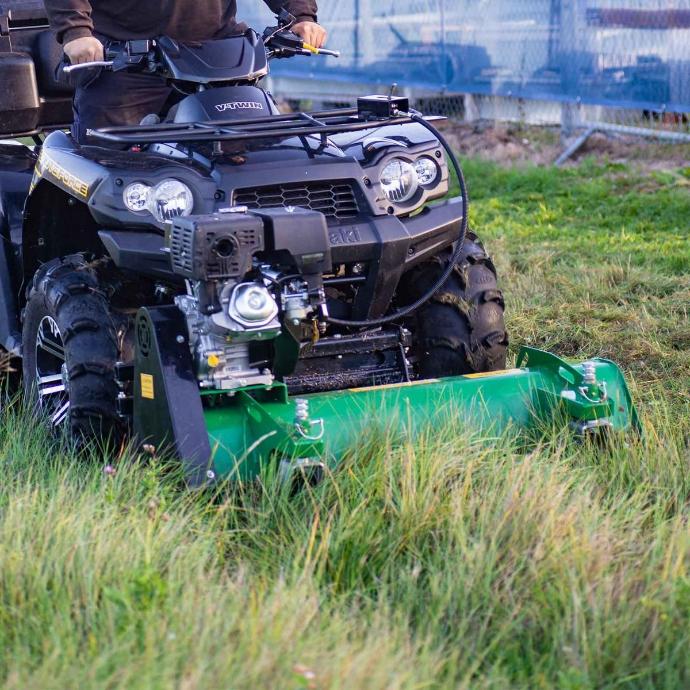 ATV front mounted mower cutting long grass with a front mounted ATV mower